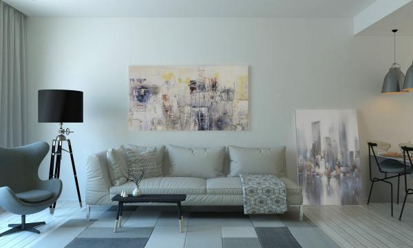 Wohnzimmer mit Sofa, Sessel und Bild an der Wand